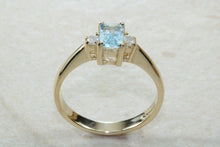 Load image into Gallery viewer, This combination of Diamond and blue Topaz trilogy ring is sure to be the gift of choice. solid 9ct yellow gold. Just the perfect gift