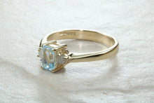 Load image into Gallery viewer, This combination of Diamond and blue Topaz trilogy ring is sure to be the gift of choice. solid 9ct yellow gold. Just the perfect gift