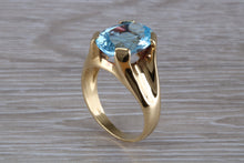 Load image into Gallery viewer, Large 9 carat Oval cut Blue Topaz set 18ct Yellow Gold Ring