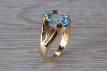 Load image into Gallery viewer, Large 9 carat Oval cut Blue Topaz set 18ct Yellow Gold Ring