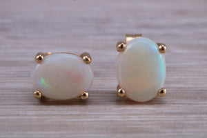 Oval cut Fiery Opal set Yellow Gold Stud Earrings