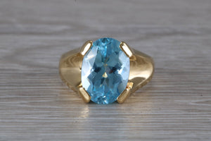 Large 9 carat Oval cut Blue Topaz set 18ct Yellow Gold Ring