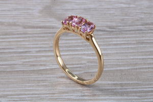 Oval Pink Topaz set Yellow Gold Trilogy Ring