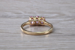 Oval Pink Topaz set Yellow Gold Trilogy Ring