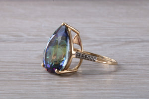 Large 13 carats Mystic Blue Topaz and Diamond set Yellow Gold Ring