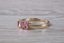 Load image into Gallery viewer, Oval Pink Topaz set Yellow Gold Trilogy Ring