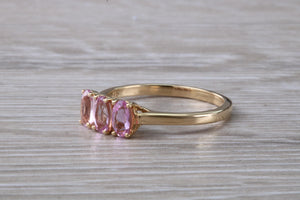 Oval Pink Topaz set Yellow Gold Trilogy Ring