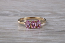 Load image into Gallery viewer, Oval Pink Topaz set Yellow Gold Trilogy Ring