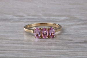 Oval Pink Topaz set Yellow Gold Trilogy Ring