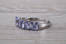 Load image into Gallery viewer, 7 stone natural Tanzanite eternity ring, oval cut Tanzanite set in 9ct white gold, one and half carats Tanzanite