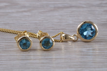 Load image into Gallery viewer, Round cut Blue Topaz Matching Earrings and Necklace set in Yellow Gold