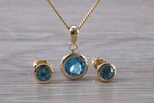 Load image into Gallery viewer, Round cut Blue Topaz Matching Earrings and Necklace set in Yellow Gold