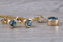 Load image into Gallery viewer, Round cut Blue Topaz Matching Earrings and Necklace set in Yellow Gold