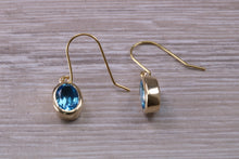 Load image into Gallery viewer, Oval cut Blue Topaz set Yellow Gold Dropper Earrings