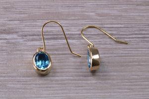 Oval cut Blue Topaz set Yellow Gold Dropper Earrings