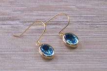 Load image into Gallery viewer, Oval cut Blue Topaz set Yellow Gold Dropper Earrings