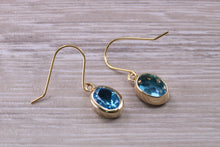 Load image into Gallery viewer, Oval cut Blue Topaz set Yellow Gold Dropper Earrings