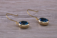 Load image into Gallery viewer, Oval cut Blue Topaz set Yellow Gold Dropper Earrings