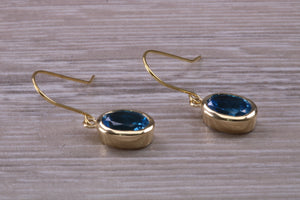 Oval cut Blue Topaz set Yellow Gold Dropper Earrings