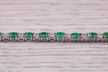 Load image into Gallery viewer, Four and Half carats Natural Emeralds and Diamonds set White Gold Tennis Bracelet, British Hallmarked