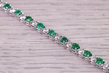 Load image into Gallery viewer, Four and Half carats Natural Emeralds and Diamonds set White Gold Tennis Bracelet, British Hallmarked