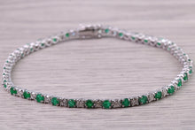 Load image into Gallery viewer, Four and Half carats Natural Emeralds and Diamonds set White Gold Tennis Bracelet, British Hallmarked