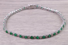 Load image into Gallery viewer, Four and Half carats Natural Emeralds and Diamonds set White Gold Tennis Bracelet, British Hallmarked