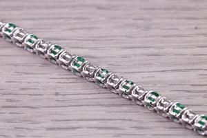 Four and Half carats Natural Emeralds and Diamonds set White Gold Tennis Bracelet, British Hallmarked