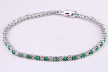 Load image into Gallery viewer, Four and Half carats Natural Emeralds and Diamonds set White Gold Tennis Bracelet, British Hallmarked